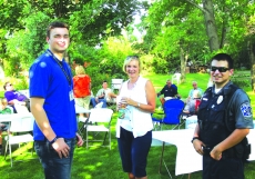 Mary Gravenish talks with police intern Nate Fafinski and Officer Michael Pfeilsticker at a neighborhood gathering hosted by Margie Solheid at 1007 Hidden Meadow Lane on National Night Out 2016.